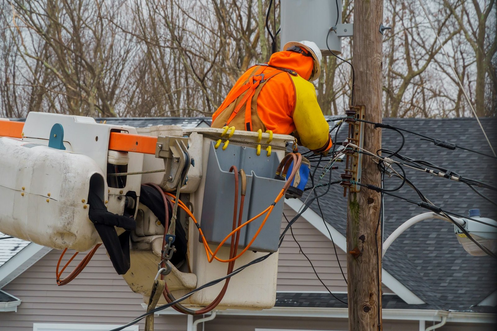 Service electrical lines men handling damage after hurricane